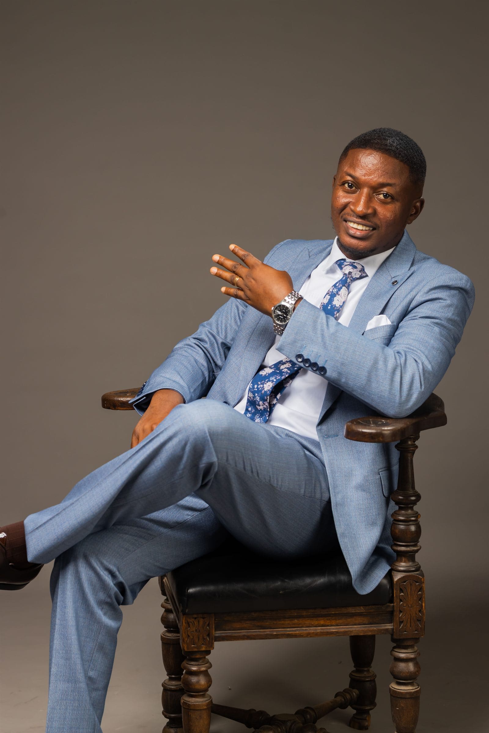 Minister Theophilus Badger in formal blue suit